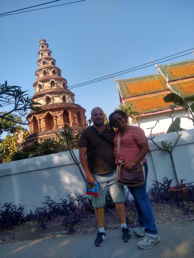 Man and woman in front of temple.