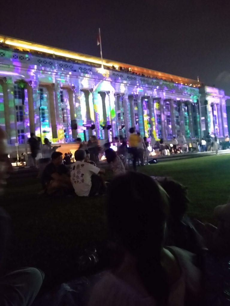 Laser lights against Singapore's National Gallery exterior. 